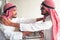 Portrait of Arabic businessman giving an handshake to his business partner after successfully dealing