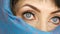 Portrait of an arabic middle aged adult woman with unusual beautiful big blue eyes with long eyelashes in traditional