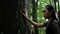 Portrait of archery woman walking fearlessly when seeing something and bravely in the jungle