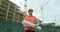 Portrait of an architect or builder in hard hat standing in front of building under construction. Close-up portrait of