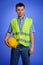 Portrait of architect in coveralls holding hardhat