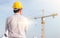 Portrait of architect wear yellow helmet safety on construction site with crane background