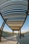 A portrait artistic fisheye view of a pavillion looking over the water, rest area and blue sky