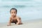 Portrait of asain infant crawling on beautiful sea beach