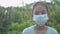 Portrait of Asian adorable female teenager wearing face mask looking at camera and staying in the rural village.