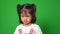 Portrait of Asian angry and sad little girl on green screen background, The emotion of a child when tantrum and mad, expression