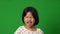 Portrait of Asian angry and sad little girl on green screen background, The emotion of a child when tantrum and mad, expression