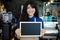 Portrait of asian barista holding blank chalkboard menu in coffee shop. Cafe restaurant service, Small business owner, food and d