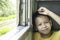 Portrait of asian boy on the train background window views and trees