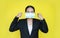 Portrait asian business woman wearing medical shielding mask isolated on yellow background