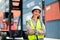 Portrait of Asian cargo container worker or technician stand with arm crossed and smile to camera in workplace area