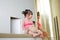 Portrait of asian child girl in swimming suit lying on sofa with reflection pole