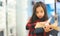 Portrait Asian child holding open textbook in hands in book store