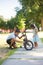 Portrait of Asian dad and nice girl repairing small bike in park