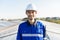 Portrait of Asian engineer on background field of photovoltaic solar panels solar cells on roof top factory.