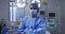 Portrait of asian female surgeon wearing face mask standing in hospital operating theatre