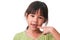 Portrait of an Asian girl with broken upper baby teeth and first permanent teeth. Friendly little girl showing her broken teeth