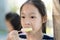 Portrait of Asian girl eating an ice-cream.