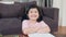 Portrait Asian girl feeling happy smiling at home. Young japanese girl relax toothy smile looking to camera while lying sofa in