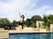 Portrait of Asian girl jumping down to swimming pool