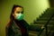 Portrait of an Asian girl in a protective disposable medical mask. stairwell of a hospital or building