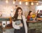 Portrait of Asian girl waitress holding menu wearing apron and standing in coffee shop0