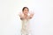 Portrait of asian little girl gesture hands spread her fingers over white background. Focus at kid face