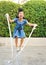 Portrait of asian little girl jumping rope in the park