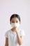 Portrait of Asian little girl wears a sanitary mask and coughs