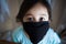 Portrait of asian Little toddler girl wearing reusable black fabric mask for protection from Coronavirus and Covid-19. Copy space