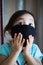 Portrait of asian Little toddler girl wearing reusable black fabric mask for protection from Coronavirus and Covid-19. Copy space