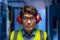 Portrait of asian male engineer wearing ear plugs in computer server room