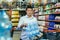 Portrait of an Asian man in crisis buying water in a supermarket