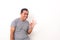 Portrait of Asian man stand happy and positive approving with a big smile and funny face expressing okay gesture isolated over