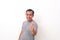 Portrait of Asian man stand happy and positive with thumbs up approving with a big smile expressing okay gesture  over