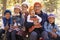 Portrait of Asian parents and four kids in a forest