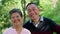Portrait of Asian Senior Couple in casual having a good time at park outdoor. Enjoying positive emotions in garden. Lovely older