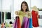 Portrait of Asian senior woman designer showing colorful paper bags product
