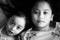 Portrait of Asian sisters siblings close up face on concrete background