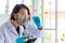 Portrait of Asian smart pharmaceutical scientist is holding pill, focusing on his tablet pill in research laboratory