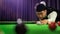 Portrait of Asian snooker player while aiming to white ball shoot to hit the snooker color ball in game on snooker table. Banner