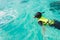 Portrait of an asian snorkeling girl with mask swiming on the se