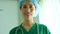 Portrait of Asian surgeon holding tablet and standing in front of operation theater at a hospital. Team of Professional surgeons.