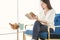 Portrait Asian woman reading book and relaxing with coffee at home.