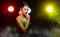 Portrait of Asian Woman Transgender wear Beautiful Green Evening long Gown, smile to camera over Back Lights colorful yellow, red