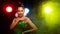 Portrait of Asian Woman Transgender wear Beautiful Green Evening long Gown, smile to camera over Back Lights colorful yellow, red