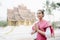 Portrait of Asian woman wearing Laos traditional clothing, acting greeting in front of the royal palace of Luang Prabang.