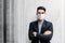 Portrait of Asian Young Businessman Wearing Surgical Mask and standing at the Wall, Smiling and Crossed Arms