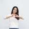 Portrait of asian young girl smiling with heart shape hand sign