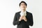 Portrait Asian young handsome businessman holding money dollars standing and smilling